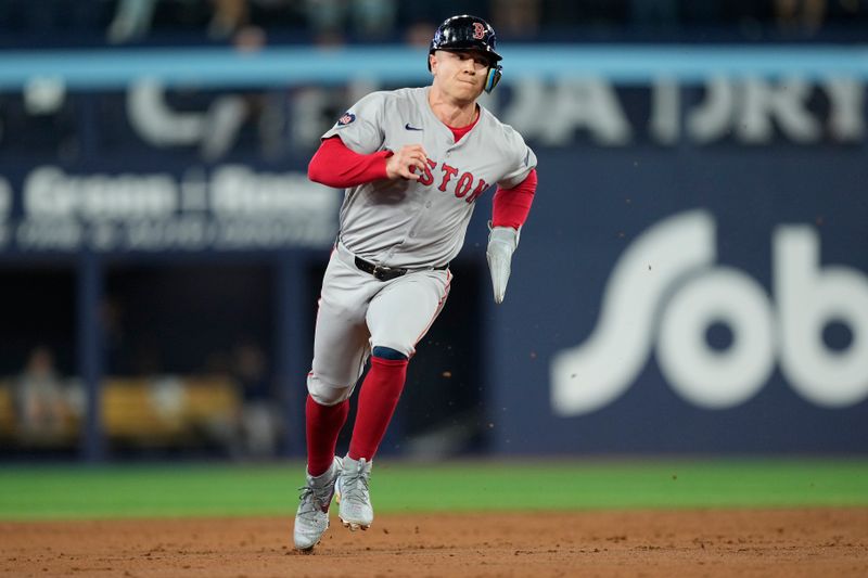 Sep 23, 2024; Toronto, Ontario, CAN; Boston Red Sox designated hitter Tyler O'Neill (17) runs to third on a double hit by right fielder Wilyer Abreu (not pictured) against the Toronto Blue Jays during the third inning at Rogers Centre. Mandatory Credit: John E. Sokolowski-Imagn Images