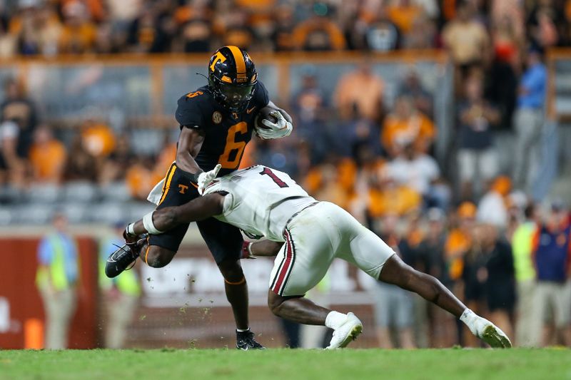 Sep 30, 2023; Knoxville, Tennessee, USA; Tennessee Volunteers running back Dylan Sampson (6) is tackled by South Carolina Gamecocks defensive back DQ Smith (1) during the second half at Neyland Stadium. Mandatory Credit: Randy Sartin-USA TODAY Sports