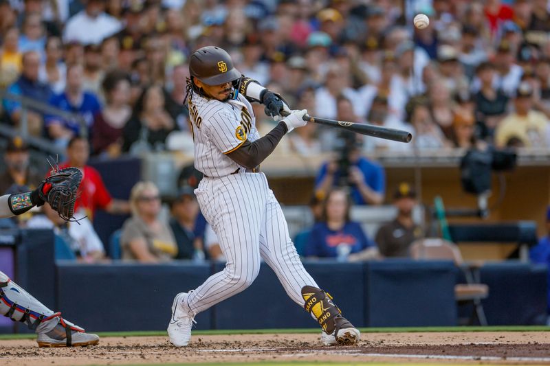 Jul 29, 2023; San Diego, California, USA; San Diego Padres catcher Luis Campusano (12) hits an RBI single to right field in the second inning against the Texas Rangers at Petco Park. Mandatory Credit: David Frerker-USA TODAY Sports