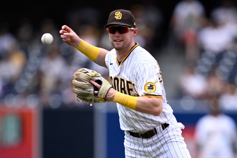 Aug 19, 2023; San Diego, California, USA; San Diego Padres second baseman Jake Cronenworth (9) cannot handle the ball on a single hit by Arizona Diamondbacks center fielder Alek Thomas (not pictured) during the sixth inning at Petco Park. Mandatory Credit: Orlando Ramirez-USA TODAY Sports