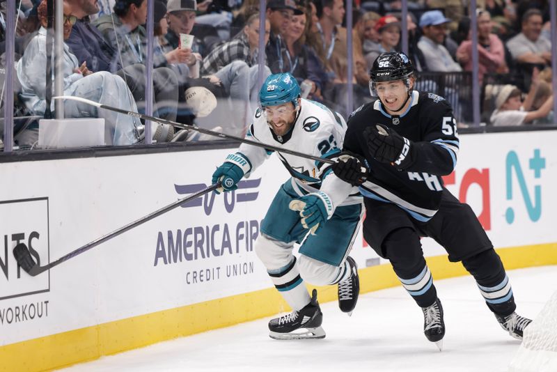 Oct 28, 2024; Salt Lake City, Utah, USA;  San Jose Sharks right wing Barclay Goodrow (23) and Utah Hockey Club defenseman Vladislav Kolyachonok (52) battle to get to the puck during the third period at Delta Center. Mandatory Credit: Chris Nicoll-Imagn Images