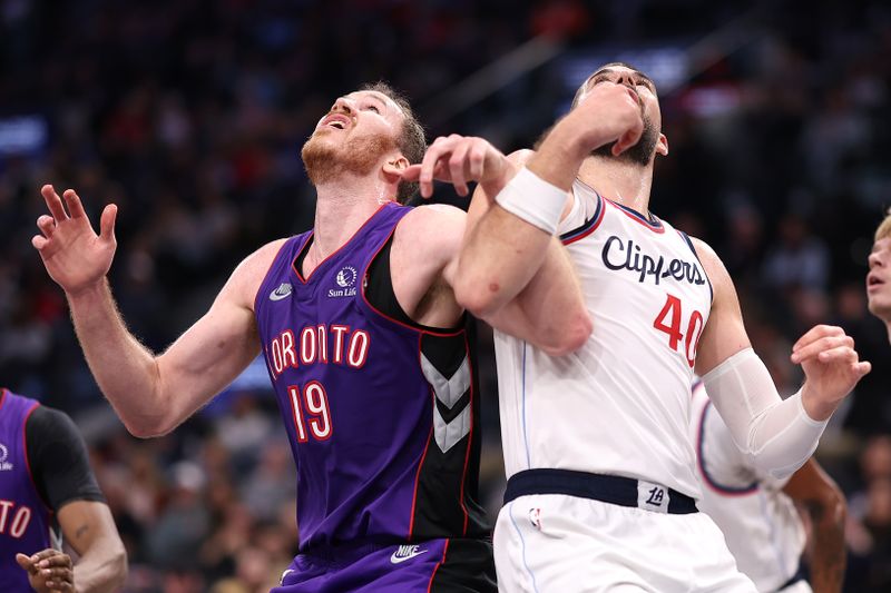 INGLEWOOD, CALIFORNIA - NOVEMBER 09: Ivica Zubac #40 of the LA Clippers battles Jakob Poeltl #19 of the Toronto Raptors for a rebound during the second half of a game at Intuit Dome on November 09, 2024 in Inglewood, California. NOTE TO USER: User expressly acknowledges and agrees that, by downloading and/or using this photograph, user is consenting to the terms and conditions of the Getty Images License Agreement. (Photo by Sean M. Haffey/Getty Images)