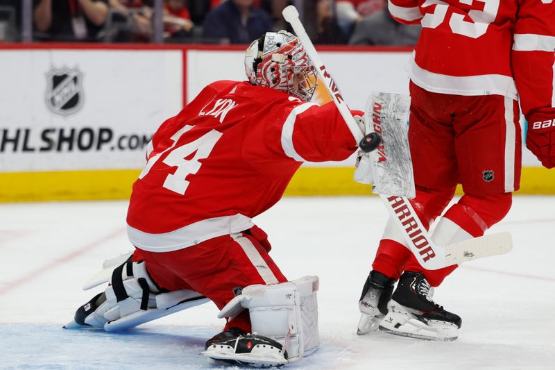 Apr 7, 2024; Detroit, Michigan, USA; Detroit Red Wings goaltender Alex Lyon (34) makes a save in the first period against the Buffalo Sabres at Little Caesars Arena. Mandatory Credit: Rick Osentoski-USA TODAY Sports