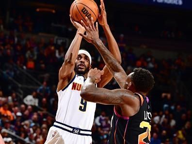 PHOENIX, AZ - DECEMBER 1: Justin Holiday #9 of the Denver Nuggets shoots the ball during the game against the Phoenix Suns on December 1, 2023 at Footprint Center in Phoenix, Arizona. NOTE TO USER: User expressly acknowledges and agrees that, by downloading and or using this photograph, user is consenting to the terms and conditions of the Getty Images License Agreement. Mandatory Copyright Notice: Copyright 2023 NBAE (Photo by Barry Gossage/NBAE via Getty Images)