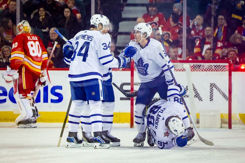 Jan 18, 2024; Calgary, Alberta, CAN; Toronto Maple Leafs right wing Mitchell Marner (16) celebrates his goal with teammates against the Calgary Flames during the second period at Scotiabank Saddledome. Mandatory Credit: Sergei Belski-USA TODAY Sports