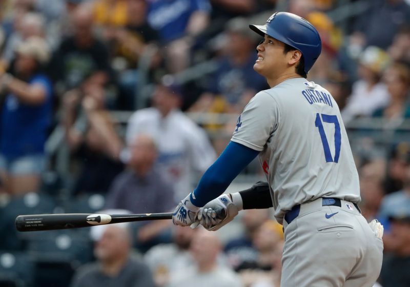 Jun 5, 2024; Pittsburgh, Pennsylvania, USA;  Los Angeles Dodgers designated hitter Shohei Ohtani (17) watches his two run home run leave the ballpark against the Pittsburgh Pirates during the third inning at PNC Park. Mandatory Credit: Charles LeClaire-USA TODAY Sports