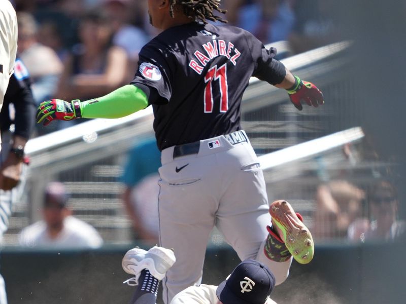 Aug 11, 2024; Minneapolis, Minnesota, USA; Minnesota Twins first baseman Jose Miranda (64) forces out Cleveland Guardians third baseman Jose Ramirez (11) at first base during the sixth inning at Target Field. Mandatory Credit: Jordan Johnson-USA TODAY Sports
