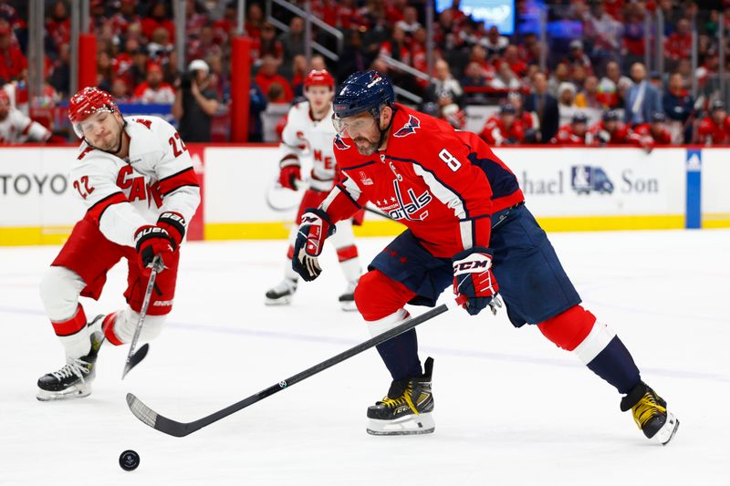 Mar 22, 2024; Washington, District of Columbia, USA; Washington Capitals left wing Alex Ovechkin (8) controls the puck as Carolina Hurricanes defenseman Brett Pesce (22) defends during the first period at Capital One Arena. Mandatory Credit: Amber Searls-USA TODAY Sports