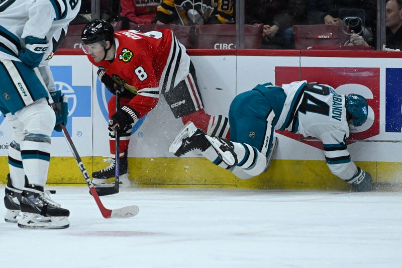 Jan 16, 2024; Chicago, Illinois, USA; Chicago Blackhawks center Ryan Donato (8) moves the puck against San Jose Sharks left wing Alexander Barabanov (94) during the first period at United Center. Mandatory Credit: Matt Marton-USA TODAY Sports