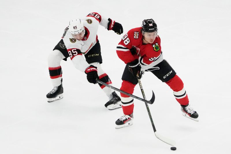 Oct 28, 2025; Chicago, Illinois, USA; Ottawa Senators defenseman Jake Sanderson (85) defends Chicago Blackhawks center Connor Bedard (98) during the first period at United Center. Mandatory Credit: David Banks-Imagn Images