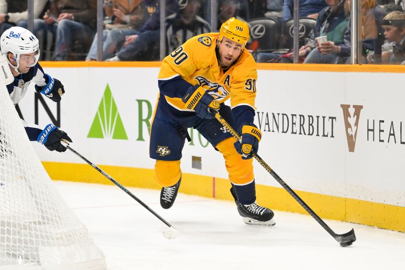 Nov 29, 2025; Nashville, Tennessee, USA;  Nashville Predators center Ryan O'Reilly (90) skates with the puck behind the net against Winnipeg Jets defenseman Josh Morrissey (44) during the third period at Bridgestone Arena. Mandatory Credit: Steve Roberts-Imagn Images