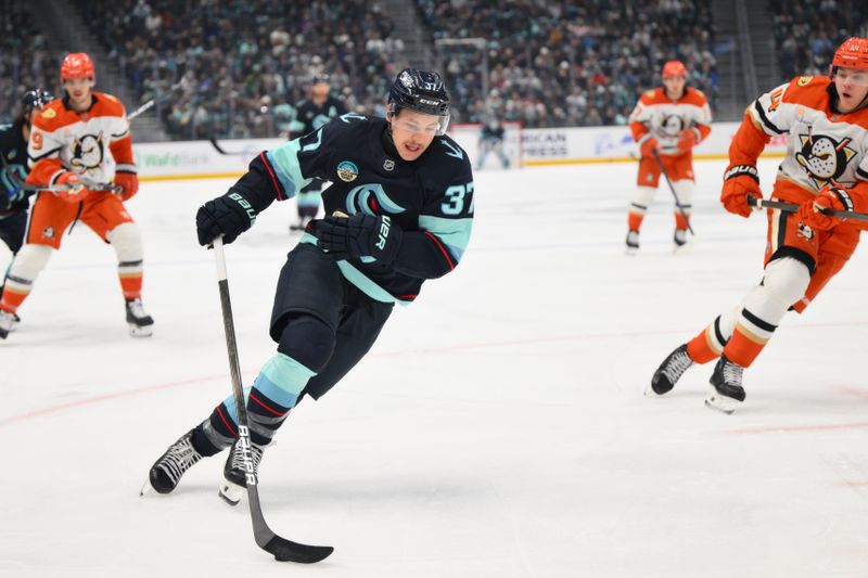 Nov 27, 2024; Seattle, Washington, USA; Seattle Kraken center Yanni Gourde (37) advances the puck against the Anaheim Ducks during the first period at Climate Pledge Arena. Mandatory Credit: Steven Bisig-Imagn Images