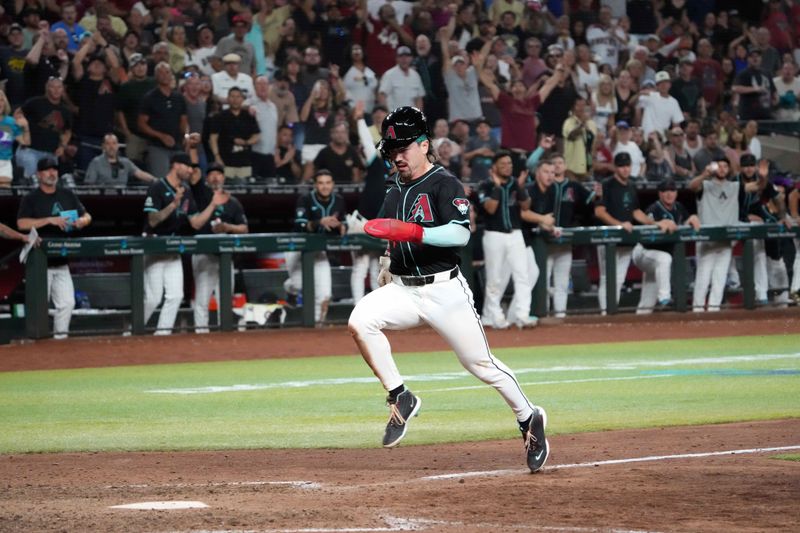 Jul 12, 2024; Phoenix, Arizona, USA; Arizona Diamondbacks outfielder Corbin Carroll (7) scores the game winning run against the Toronto Blue Jays during the ninth inning at Chase Field. Mandatory Credit: Joe Camporeale-USA TODAY Sports