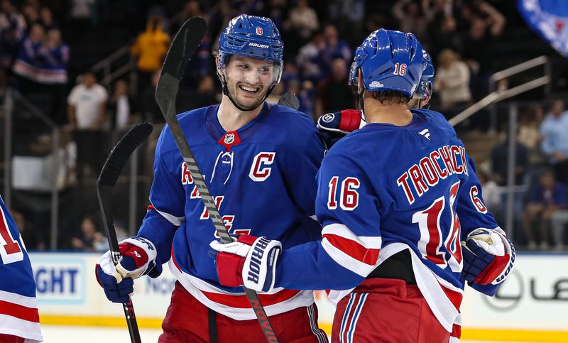 Sep 24, 2024; New York, New York, USA; New York Rangers defenseman Jacob Trouba (8) celebrates a goal with center Vincent Trocheck (16) during the third period against the New York Islanders at Madison Square Garden. Mandatory Credit: Danny Wild-Imagn Images