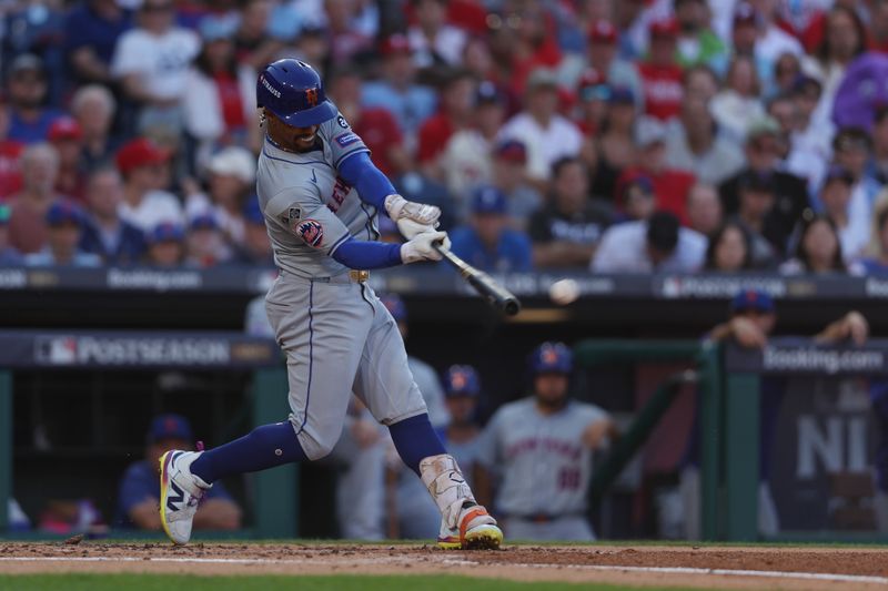 Oct 6, 2024; Philadelphia, Pennsylvania, USA; New York Mets shortstop Francisco Lindor (12) hits a single in the third inning against the Philadelphia Phillies during game two of the NLDS for the 2024 MLB Playoffs at Citizens Bank Park. Mandatory Credit: Bill Streicher-Imagn Images