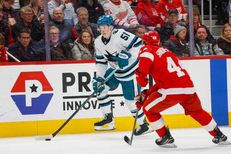 Jan 16, 2026; Detroit, Michigan, USA; San Jose Sharks right wing Collin Graf (51) handles the puck against Detroit Red Wings defenseman Axel Sandin-Pellikka (44) during the first period at Little Caesars Arena. Mandatory Credit: Brian Bradshaw Sevald-Imagn Images