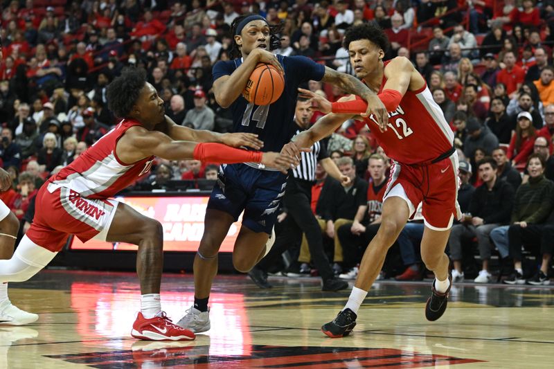 Jan 28, 2023; Las Vegas, Nevada, USA; Nevada Wolf Pack forward Tre Coleman (14) drives to the net past UNLV Runnin' Rebels guard Shane Nowell (3) and center David Muoka (12) in the first half at Thomas & Mack Center. Mandatory Credit: Candice Ward-USA TODAY Sports