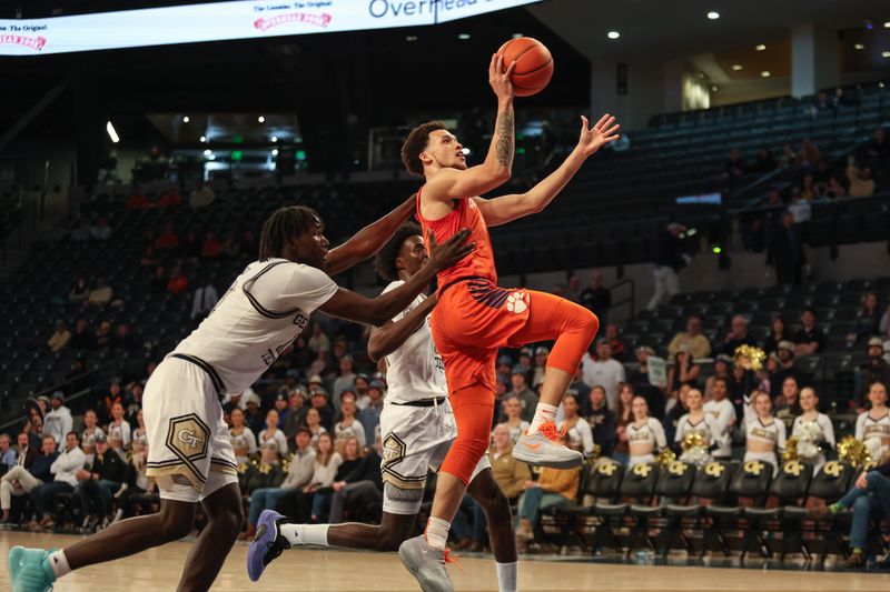 Jan 14, 2025; Atlanta, Georgia, USA; Georgia Tech Yellow Jackets forward Baye Ndongo (11) fouls Clemson Tigers guard Chase Hunter (1) during the second half at McCamish Pavilion. Mandatory Credit: Jordan Godfree-Imagn Images