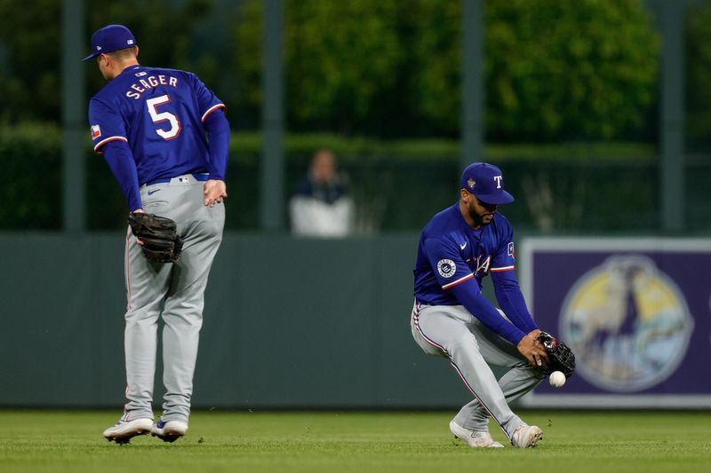 May 10, 2024; Denver, Colorado, USA; Texas Rangers center fielder Leody Taveras (3) is unable make a catch ahead of shortstop Corey Seager (5) in the seventh inning against the Colorado Rockies at Coors Field. Mandatory Credit: Isaiah J. Downing-USA TODAY Sports