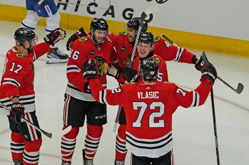 Nov 24, 2023; Chicago, Illinois, USA; Chicago Blackhawks center Jason Dickinson (16) celebrates his hat trick against the Toronto Maple Leafs during the third period at United Center. Mandatory Credit: David Banks-USA TODAY Sports