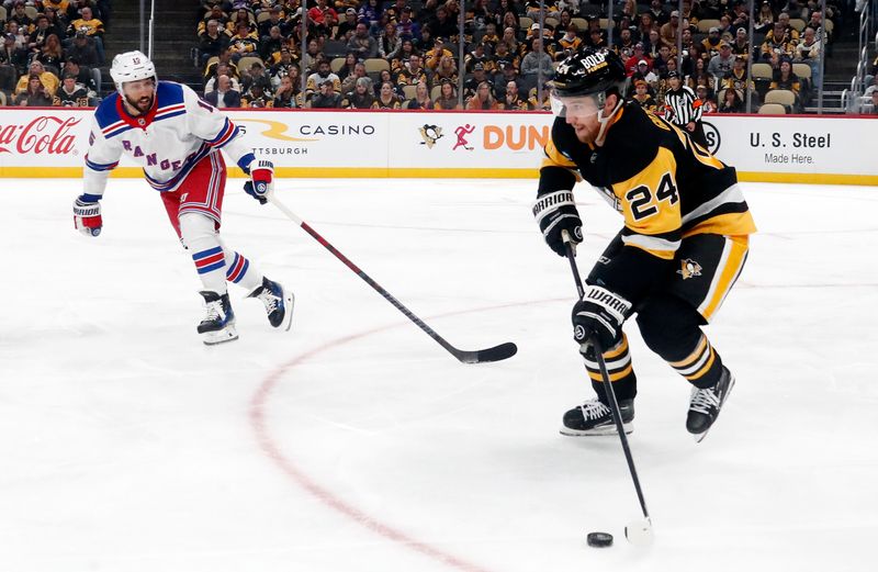 Oct 9, 2024; Pittsburgh, Pennsylvania, USA;  Pittsburgh Penguins defenseman Matt Grzelcyk (24) moves the puck against New York Rangers center Vincent Trocheck (16) during the second period at PPG Paints Arena. Mandatory Credit: Charles LeClaire-Imagn Images