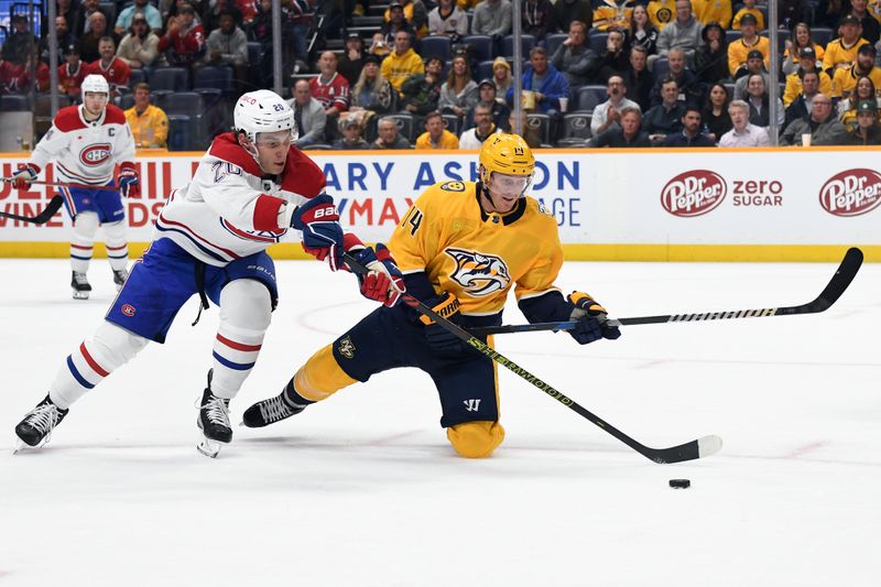 Mar 5, 2024; Nashville, Tennessee, USA; Nashville Predators center Gustav Nyquist (14) is played off the puck by Montreal Canadiens left wing Juraj Slafkovsky (20) during the first period at Bridgestone Arena. Mandatory Credit: Christopher Hanewinckel-USA TODAY Sports