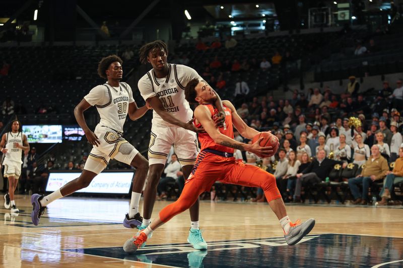 Jan 14, 2025; Atlanta, Georgia, USA; Georgia Tech Yellow Jackets forward Baye Ndongo (11) fouls Clemson Tigers guard Chase Hunter (1) during the second half at McCamish Pavilion. Mandatory Credit: Jordan Godfree-Imagn Images