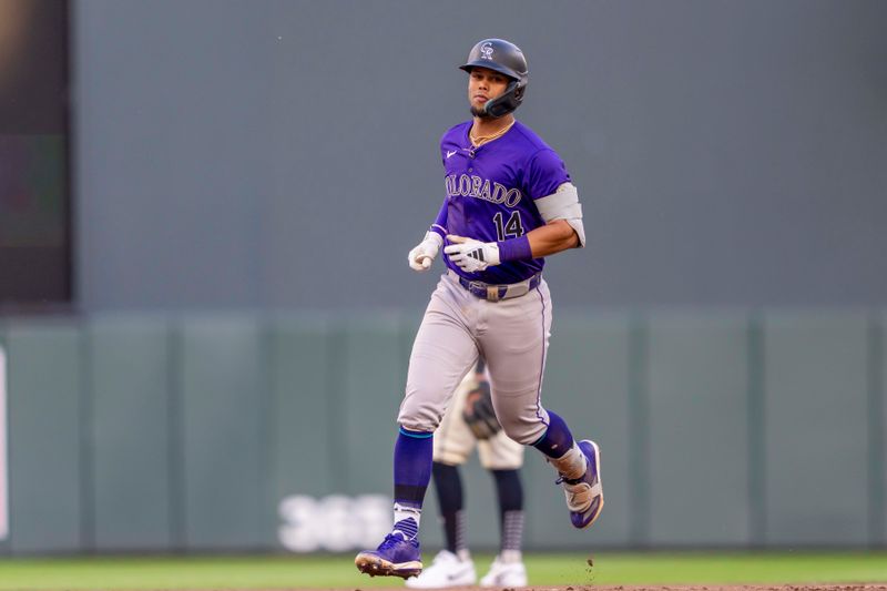 Jun 11, 2024; Minneapolis, Minnesota, USA; Colorado Rockies shortstop Ezequiel Tovar (14) rounds second base after hitting a three run home run against the Minnesota Twins in the sixth inning at Target Field. Mandatory Credit: Jesse Johnson-USA TODAY Sports