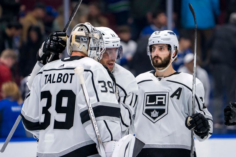 Mar 25, 2024; Vancouver, British Columbia, CAN; Los Angeles Kings goalie Cam Talbot (39) and forward Anze Kopitar (11) and forward Phillip Danault (24) celebrate their victory against the Vancouver Canucks at Rogers Arena. Kings won 3 -2. Mandatory Credit: Bob Frid-USA TODAY Sports