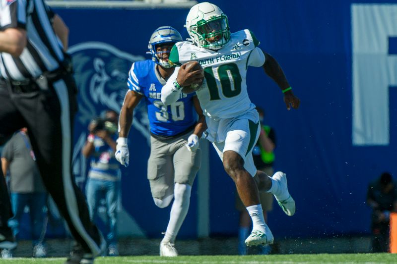 Nov 7, 2020; Memphis, Tennessee, USA; South Florida Bulls running back Kelley Joiner Jr. (10) carries the ball during the first half against Memphis Tigers defensive back Rodney Owens (30)  at Liberty Bowl Memorial Stadium. Mandatory Credit: Justin Ford-USA TODAY Sports