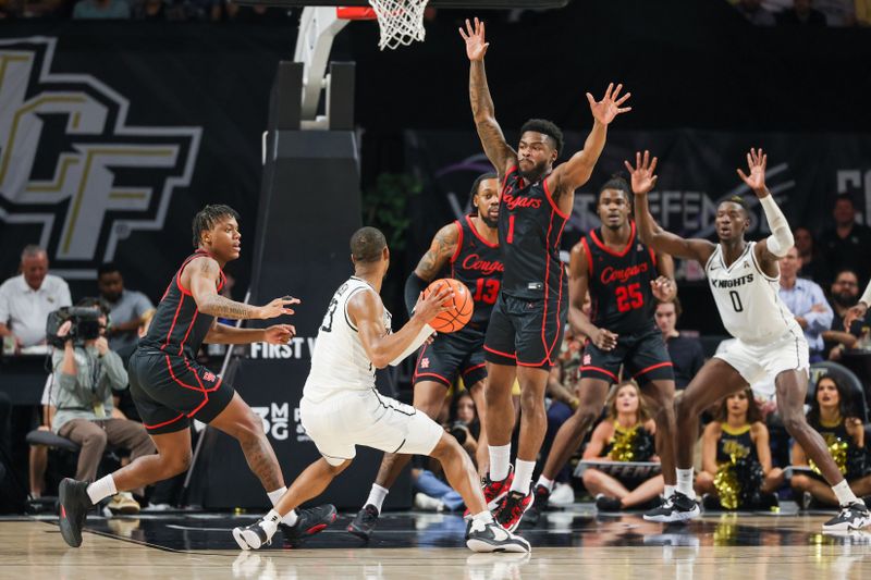 Jan 25, 2023; Orlando, Florida, USA; UCF Knights guard C.J. Kelly (13) looks to pass against Houston Cougars guard Jamal Shead (1) during the second half at Addition Financial Arena. Mandatory Credit: Mike Watters-USA TODAY Sports