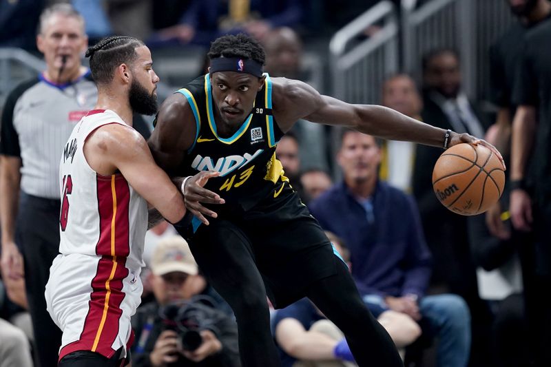 INDIANAPOLIS, INDIANA - APRIL 07: Pascal Siakam #43 of the Indiana Pacers dribbles the ball while being guarded by Caleb Martin #16 of the Miami Heat in the second quarter at Gainbridge Fieldhouse on April 07, 2024 in Indianapolis, Indiana. NOTE TO USER: User expressly acknowledges and agrees that, by downloading and or using this photograph, User is consenting to the terms and conditions of the Getty Images License Agreement. (Photo by Dylan Buell/Getty Images)