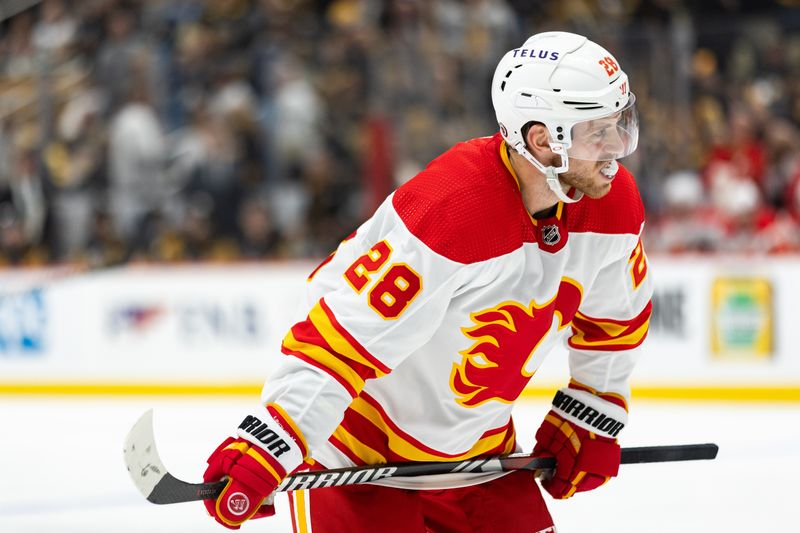 Oct 14, 2023; Pittsburgh, Pennsylvania, USA; Calgary Flames center Elias Lindholm (28) chews on his mouthguard during a break in play against the Pittsburgh Penguins during the second period at PPG Paints Arena. Mandatory Credit: Scott Galvin-USA TODAY Sports