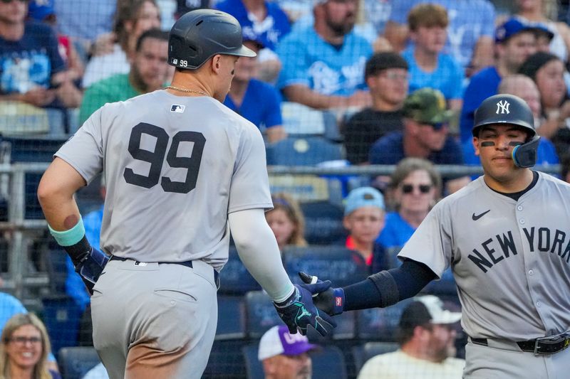 Jun 12, 2024; Kansas City, Missouri, USA;  New York Yankees center fielder Aaron Judge (99) celebrates with New York Yankees catcher Jose Trevino (39) after scoring against the Kansas City Royals at Kauffman Stadium. Mandatory Credit: Denny Medley-USA TODAY Sports