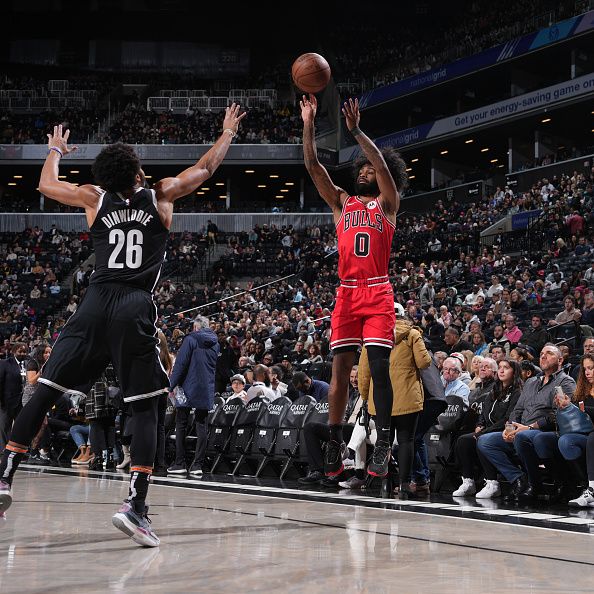 BROOKLYN, NY - NOVEMBER 26: Coby White #0 of the Chicago Bulls shoots a three point basket against the Brooklyn Nets on November 26, 2023 at Barclays Center in Brooklyn, New York. NOTE TO USER: User expressly acknowledges and agrees that, by downloading and or using this Photograph, user is consenting to the terms and conditions of the Getty Images License Agreement. Mandatory Copyright Notice: Copyright 2023 NBAE (Photo by Jesse D. Garrabrant/NBAE via Getty Images)