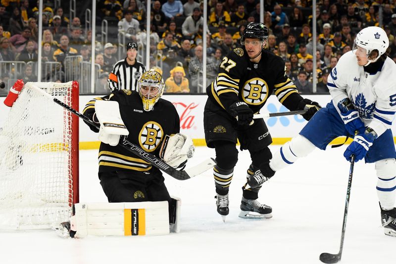 May 4, 2024; Boston, Massachusetts, USA; Boston Bruins goaltender Jeremy Swayman (1) follows the puck while defenseman Hampus Lindholm (27) defends Toronto Maple Leafs left wing Tyler Bertuzzi (59) during the second period in game seven of the first round of the 2024 Stanley Cup Playoffs at TD Garden. Mandatory Credit: Bob DeChiara-USA TODAY Sports