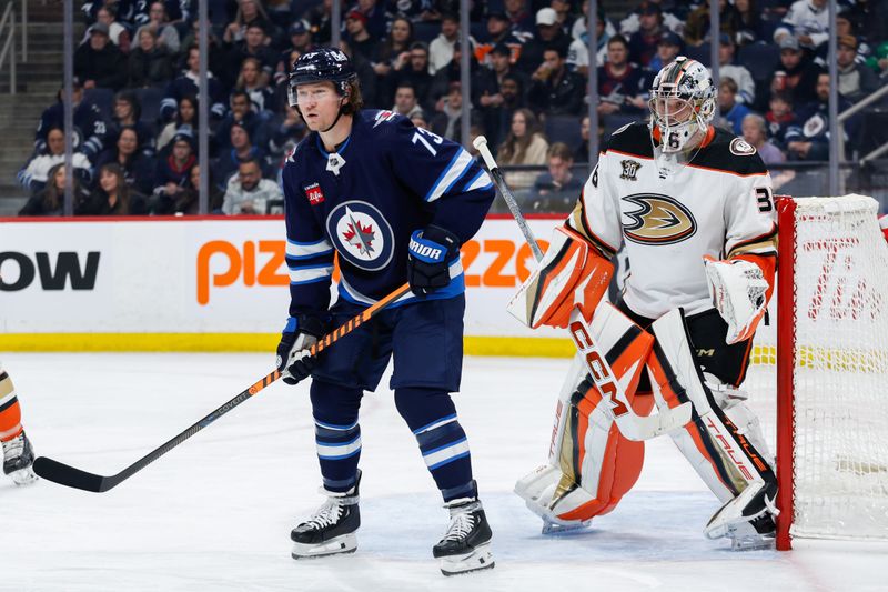 Mar 15, 2024; Winnipeg, Manitoba, CAN; Winnipeg Jets forward Tyler T0ffoli (73) and Anaheim Ducks goalie John Gibson (36) look for the puck during the second period at Canada Life Centre. Mandatory Credit: Terrence Lee-USA TODAY Sports