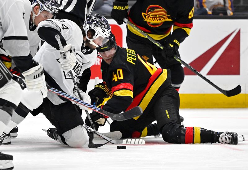 Apr 10, 2023; Los Angeles, California, USA;  Los Angeles Kings center Phillip Danault (24) and Vancouver Canucks center Elias Pettersson (40) go for the puck on a face off in the first period at Crypto.com Arena. Mandatory Credit: Jayne Kamin-Oncea-USA TODAY Sports