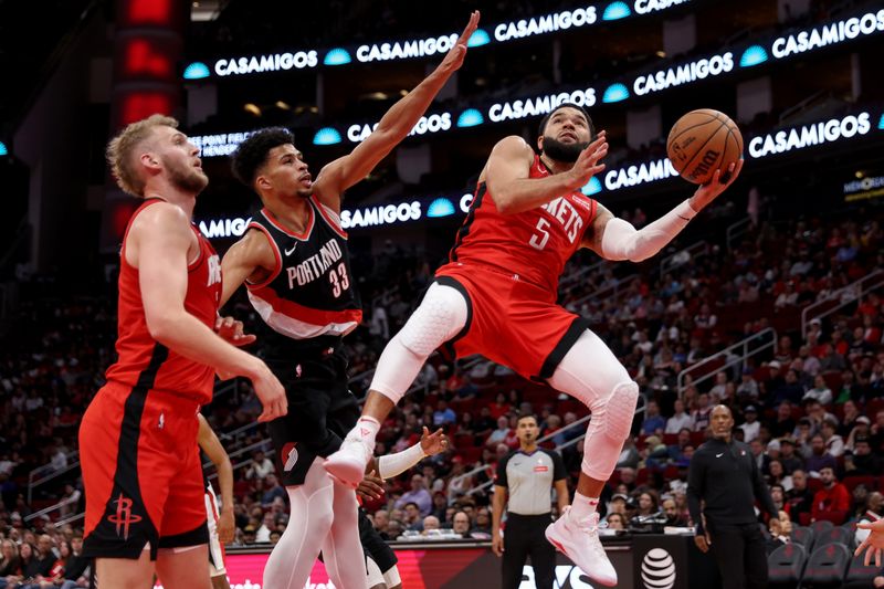 HOUSTON, TEXAS - MARCH 25: Fred VanVleet #5 of the Houston Rockets shoots the ball while defended by Toumani Camara #33 of the Portland Trail Blazers in the second half at Toyota Center on March 25, 2024 in Houston, Texas.  NOTE TO USER: User expressly acknowledges and agrees that, by downloading and or using this photograph, User is consenting to the terms and conditions of the Getty Images License Agreement. (Photo by Tim Warner/Getty Images)