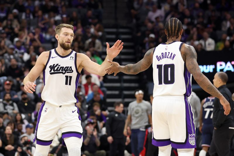 SACRAMENTO, CALIFORNIA - NOVEMBER 08: Domantas Sabonis #11 high-fives DeMar DeRozan #10 of the Sacramento Kings in the first half of their game against the LA Clippers at Golden 1 Center on November 08, 2024 in Sacramento, California. NOTE TO USER: User expressly acknowledges and agrees that, by downloading and/or using this photograph, user is consenting to the terms and conditions of the Getty Images License Agreement.  (Photo by Ezra Shaw/Getty Images)