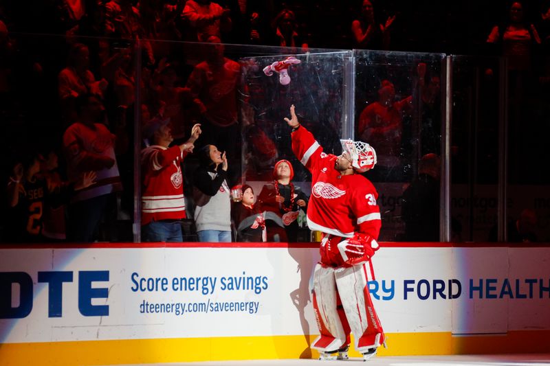 Nov 2, 2024; Detroit, Michigan, USA; Detroit Red Wings goaltender Cam Talbot (39) throws a stuffed octopus into the crowd following the Detroit Red Wings win over the Buffalo Sabres at Little Caesars Arena. Mandatory Credit: Brian Bradshaw Sevald-Imagn Images