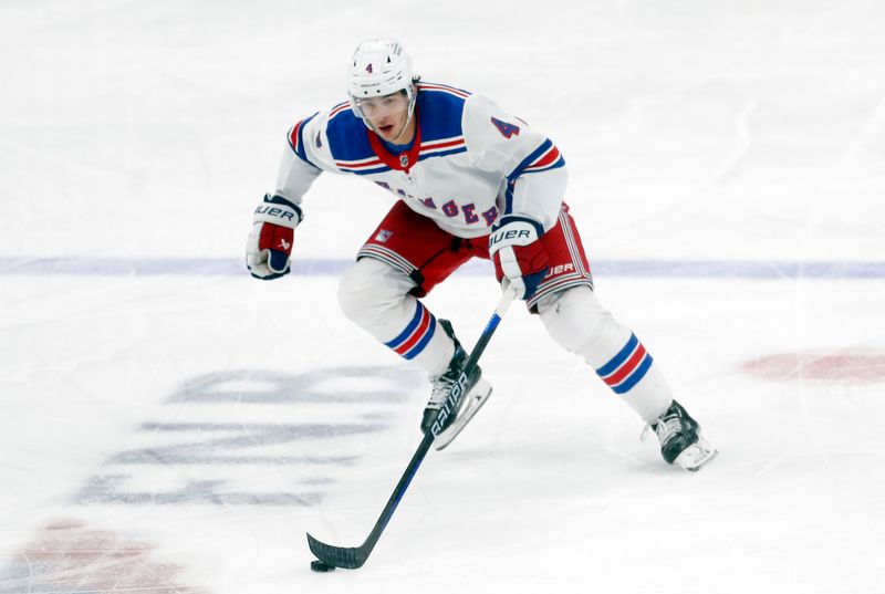 Mar 16, 2024; Pittsburgh, Pennsylvania, USA;  New York Rangers defenseman Braden Schneider (4) skates up ice with the puck against the Pittsburgh Penguins during the third period at PPG Paints Arena. New York won 7-4. Mandatory Credit: Charles LeClaire-USA TODAY Sports