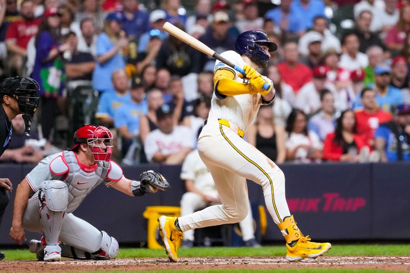 Sep 17, 2024; Milwaukee, Wisconsin, USA;  Milwaukee Brewers center fielder Garrett Mitchell (5) hits and RBI triple during the fourth inning against the Philadelphia Phillies at American Family Field. Mandatory Credit: Jeff Hanisch-Imagn Images