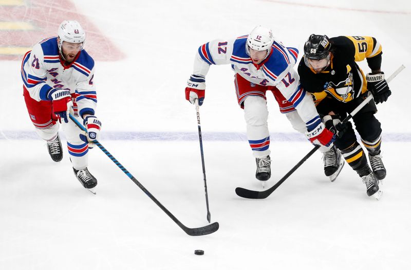 Nov 22, 2023; Pittsburgh, Pennsylvania, USA; New York Rangers center Barclay Goodrow (21) and center Nick Bonino (12) chase the puck against Pittsburgh Penguins defenseman Kris Letang (58) during the third period at PPG Paints Arena. The Rangers won 1-0. Mandatory Credit: Charles LeClaire-USA TODAY Sports