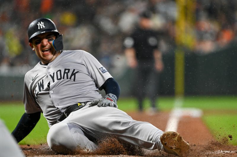 Jul 12, 2024; Baltimore, Maryland, USA;  New York Yankees catcher Jose Trevino (39) slides to score in the ninth inning against the Baltimore Orioles at Oriole Park at Camden Yards. Mandatory Credit: Tommy Gilligan-USA TODAY Sports