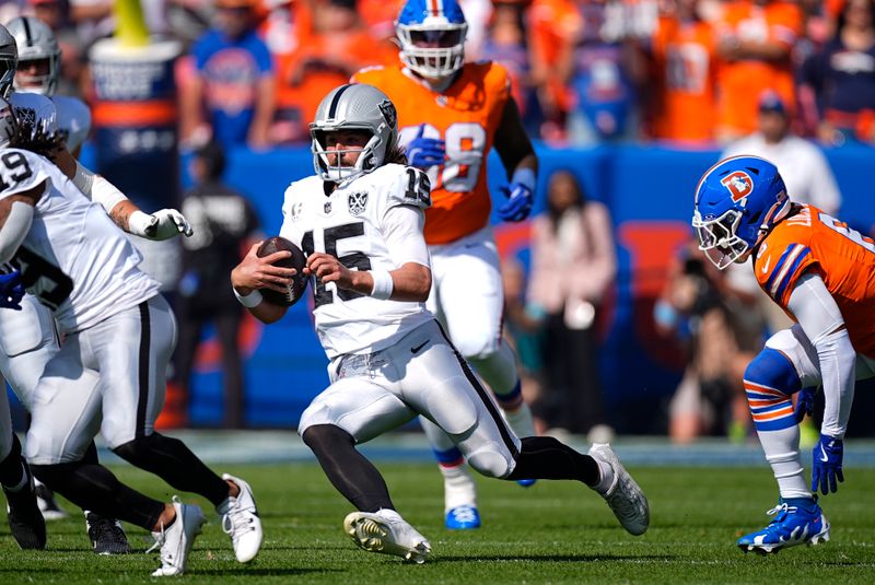 Las Vegas Raiders quarterback Gardner Minshew scrambles during the first half of an NFL football game against the Denver Broncos, Sunday, Oct. 6, 2024, in Denver. (AP Photo/David Zalubowski)