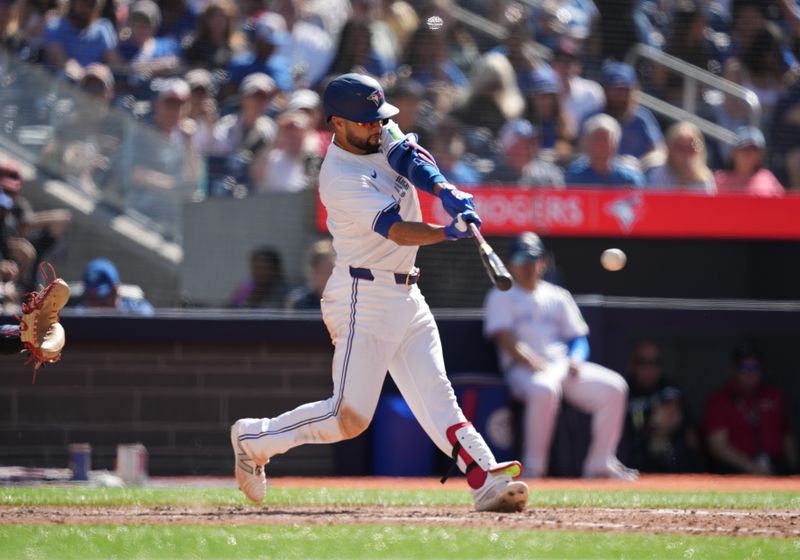 Jun 15, 2024; Toronto, Ontario, CAN; Toronto Blue Jays shortstop Isiah Kiner-Falefa (7) hits a single against the Cleveland Guardians during the sixth inning at Rogers Centre. Mandatory Credit: Nick Turchiaro-USA TODAY Sports