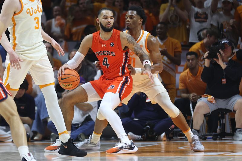 Feb 28, 2024; Knoxville, Tennessee, USA; Auburn Tigers forward Johni Broome (4) moves the ball against Tennessee Volunteers forward Tobe Awaka (11) during the second half at Thompson-Boling Arena at Food City Center. Mandatory Credit: Randy Sartin-USA TODAY Sports