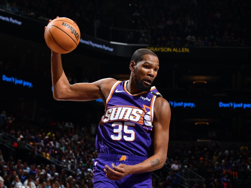 PHOENIX, AZ - NOVEMBER 30: Kevin Durant #35 of the Phoenix Suns rebounds the ball during the game against the Golden State Warriors on November 30, 2024 at Footprint Center in Phoenix, Arizona. NOTE TO USER: User expressly acknowledges and agrees that, by downloading and or using this photograph, user is consenting to the terms and conditions of the Getty Images License Agreement. Mandatory Copyright Notice: Copyright 2024 NBAE (Photo by Barry Gossage/NBAE via Getty Images)