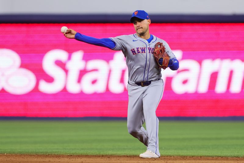 Jul 21, 2024; Miami, Florida, USA; New York Mets second baseman Jose Iglesias (11) throws to first base to retire Miami Marlins second baseman Xavier Edwards (not pictured) during the sixth inning at loanDepot Park. Mandatory Credit: Sam Navarro-USA TODAY Sports